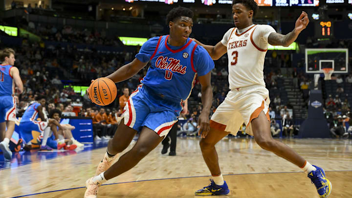 Mar 11, 2026; Nashville, TN, USA;  Mississippi Rebels forward Malik Dia (0) drives baseline past Texas Longhorns forward Dailyn Swain (3) during the second half at Bridgestone Arena. Mandatory Credit: Steve Roberts-Imagn Images