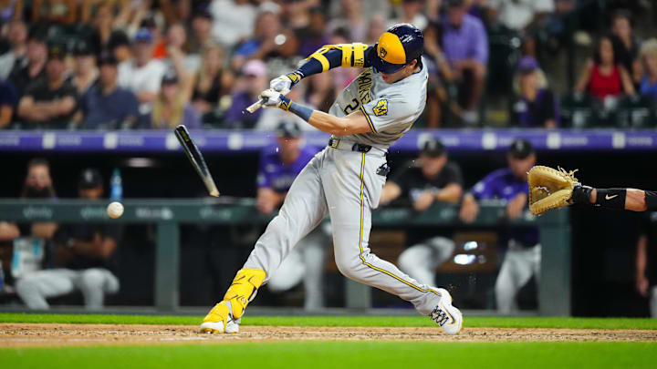 Jul 2, 2024; Denver, Colorado, USA; Milwaukee Brewers outfielder Christian Yelich (22) singles in the ninth inning against the Colorado Rockies at Coors Field. Mandatory Credit: Ron Chenoy-Imagn Images