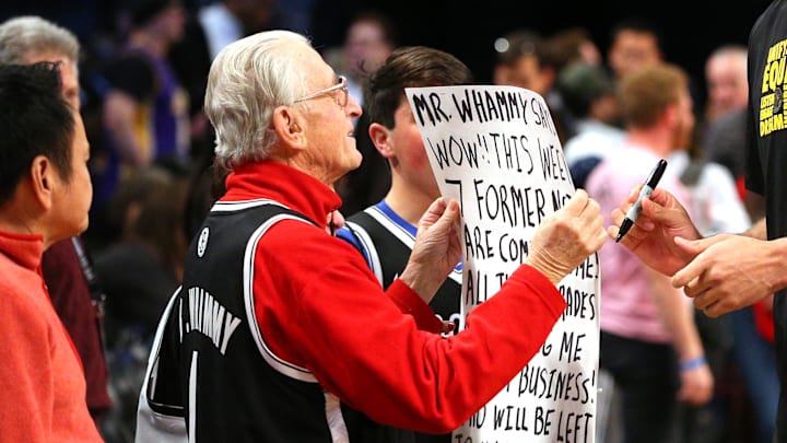 Feb 2, 2018; Brooklyn, NY, USA; Los Angeles Lakers center Brook Lopez (11) signs an autograph for Nets fan Mr. Whammy during warms up before a game against the Brooklyn Nets at Barclays Center. Mandatory Credit: Brad Penner-Imagn Images