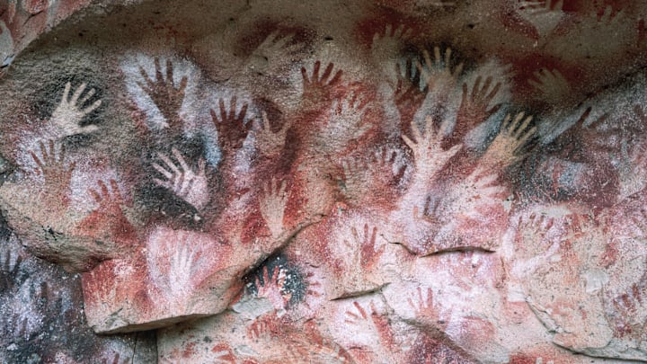 Stenciled human hands in a cave near Rio Pinturas, Argentina, dating from the last ice age.