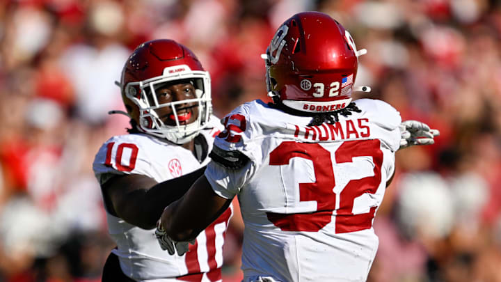 Oct 11, 2025; Dallas, Texas, USA; Oklahoma Sooners defensive lineman R Mason Thomas (32) and linebacker Kip Lewis (10) celebrate during the game between the Texas Longhorns and the Oklahoma Sooners at the Cotton Bowl. Mandatory Credit: Jerome Miron-Imagn Images