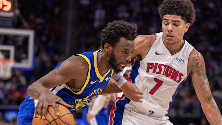 Nov 6, 2023; Detroit, Michigan, USA; Detroit Pistons guard Killian Hayes (7) defends against Golden State Warriors forward Andrew Wiggins (22) during the in the second half at Little Caesars Arena. Mandatory Credit: David Reginek-Imagn Images