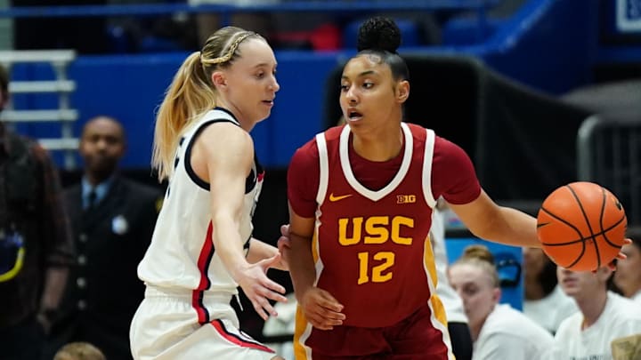 Dec 21, 2024; Hartford, Connecticut, USA; USC Trojans guard JuJu Watkins (12) dribbles the ball against UConn Huskies guard Paige Bueckers (5) in the first half at XL Center. Mandatory Credit: David Butler II-Imagn Images