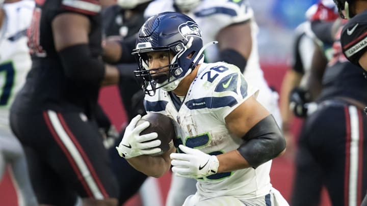 Dec 8, 2024; Glendale, Arizona, USA; Seattle Seahawks running back Zach Charbonnet (26) against the Arizona Cardinals at State Farm Stadium. Mandatory Credit: Mark J. Rebilas-Imagn Images