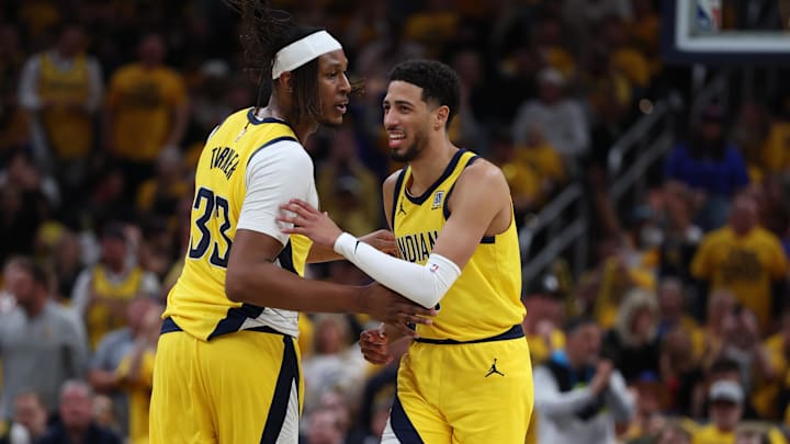 May 27, 2025; Indianapolis, Indiana, USA; Indiana Pacers guard Tyrese Haliburton (0) reacts with center Myles Turner (33) after shooting a three point basket during the second quarter against the New York Knicks of game four of the eastern conference finals for the 2025 NBA Playoffs at Gainbridge Fieldhouse. Mandatory Credit: Trevor Ruszkowski-Imagn Images