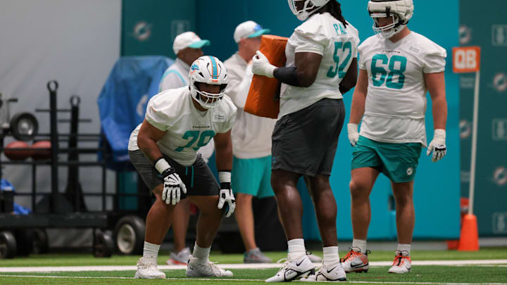 Miami Dolphins offensive tackle Larry Borom (79) works with offensive tackle Patrick Paul (52) during training camp at Baptist Health Training Complex.