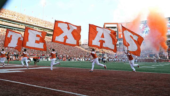 Sep 12, 2026; Austin, Texas, USA; Members of the Texas Longhorns spirit squad carry flags on to the field before a game against the Ohio State Buckeyes at Darrell K Royal-Texas Memorial Stadium. Mandatory Credit: Scott Wachter-Imagn Images Sep 12, 2026; Austin, Texas, USA; Members of the Texas Longhorns spirit squad carry flags on to the field before a game against the Ohio State Buckeyes at Darrell K Royal-Texas Memorial Stadium. Mandatory Credit: Scott Wachter-Imagn Images