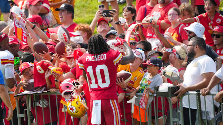 Jul 26, 2024; Kansas City, MO, USA; Kansas City Chiefs running back Isiah Pacheco (10) signs autographs for fans after training camp at Missouri Western State University. Mandatory Credit: Denny Medley-Imagn Images