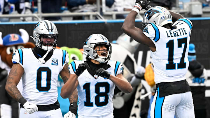 Dec 15, 2024; Charlotte, North Carolina, USA; Carolina Panthers wide receiver Jalen Coker (18) celebrates with tight end Ja'Tavion Sanders (0) and wide receiver Xavier Legette (17) after scoring a touchdown in the second quarter at Bank of America Stadium. 