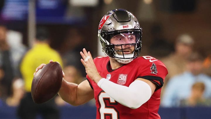 Nov 23, 2025; Inglewood, California, USA; Tampa Bay Buccaneers quarterback Baker Mayfield (6) looks to pass the ball while running outside the pocket against the Los Angeles Rams during the first quarter at SoFi Stadium. 