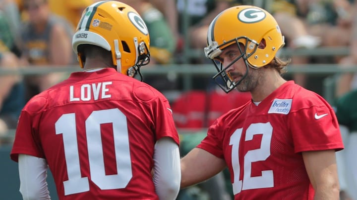 Green Bay Packers quarterback Aaron Rodgers (12) talks with quarterback Jordan Love (10) during the first day of training camp on July 28, 2021 in Green Bay, Wis.