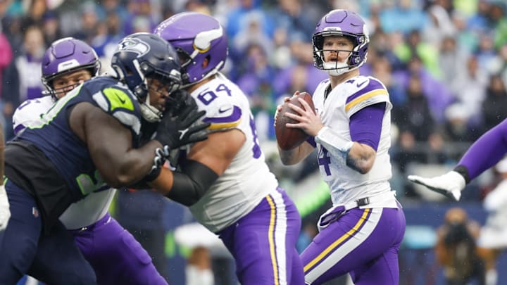 Dec 22, 2024; Seattle, Washington, USA; Minnesota Vikings quarterback Sam Darnold (14) looks to pass against the Seattle Seahawks during the first quarter at Lumen Field.