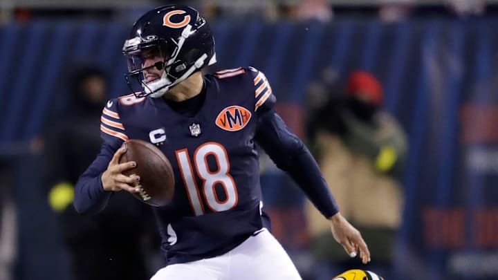 Chicago Bears quarterback Caleb Williams (18) eludes Green Bay Packers defensive end Rashan Gary (52) during their football game Saturday, December 20, 2025, at Soldier Field in Chicago, Illinois.