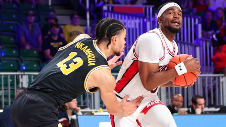 Nov 24, 2023; Paradise Island, BAHAMAS;  Texas Tech Red Raiders forward Devan Cambridge (35) drives to the basket as Michigan Wolverines forward Olivier Nkamhoua (13) defends during the first half at Imperial Arena. Mandatory Credit: Kevin Jairaj-USA TODAY Sports