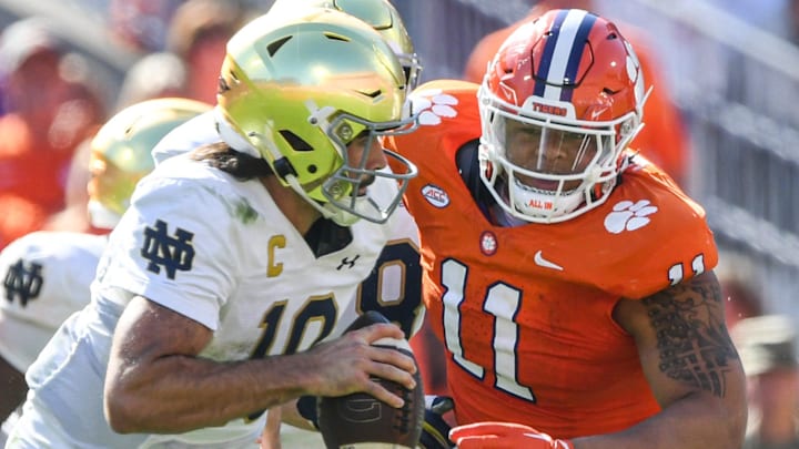 Notre Dame quarterback Sam Hartman (10) runs by Clemson defensive lineman Peter Woods (11) for a touchdown during the third quarter at Memorial Stadium in Clemson, S.C. Saturday, November 4, 2023.