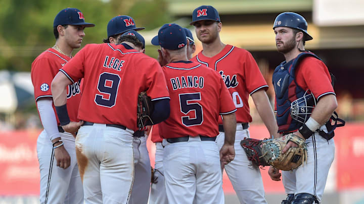 Head coach Mike Bianco (5) huddles with his players during the Ole Miss vs. Mississippi State
