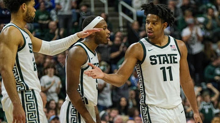 Michigan State players A.J. Hoggard (11), right, Tre Holloman (5), center, and Malik Hall (25)