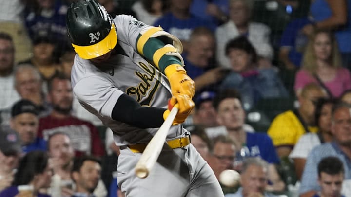 Sep 16, 2024; Chicago, Illinois, USA; Oakland Athletics outfielder Brent Rooker (25) hits a single against the Chicago Cubs during the fifth inning at Wrigley Field. Mandatory Credit: David Banks-Imagn Images Sep 16, 2024; Chicago, Illinois, USA; Oakland Athletics outfielder Brent Rooker (25) hits a single against the Chicago Cubs during the fifth inning at Wrigley Field. Mandatory Credit: David Banks-Imagn Images