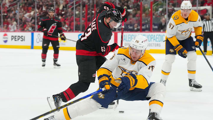 Dec 6, 2025; Raleigh, North Carolina, USA;  Carolina Hurricanes right wing Jackson Blake (53) cuts inside of Nashville Predators defenseman Brady Skjei (76) during the first period at Lenovo Center. Mandatory Credit: James Guillory-Imagn Images