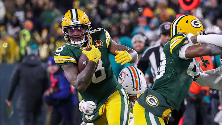 Green Bay Packers running back Josh Jacobs (8) runs the ball against the Miami Dolphins on Thanksgiving.