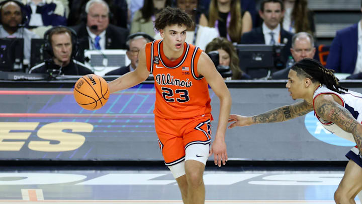 Apr 4, 2026; Indianapolis, IN, USA; Illinois Fighting Illini guard Keaton Wagler (23) dribbles the ball against UConn Huskies guard Solo Ball (1) in the first half during a semifinal of the Final Four of the men's 2026 NCAA Tournament at Lucas Oil Stadium. Mandatory Credit: Trevor Ruszkowski-Imagn Images