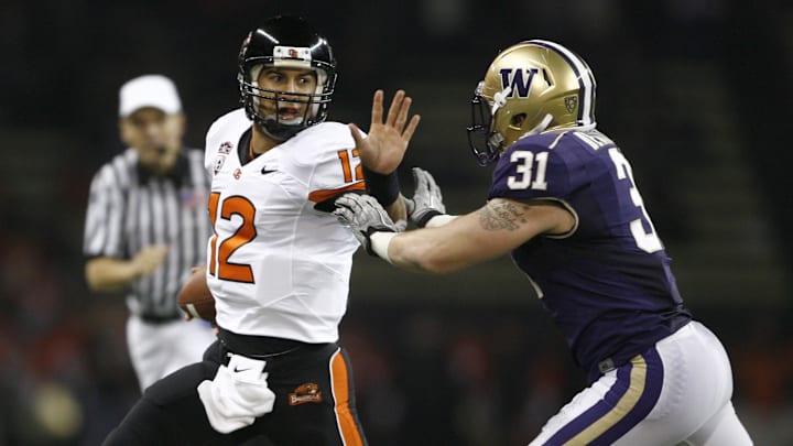 Cort Dennison rushes Oregon State QB Ryan Katz in 2010. Dennison is now a Beavers coach. Cort Dennison rushes Oregon State QB Ryan Katz in 2010. Dennison is now a Beavers coach.
