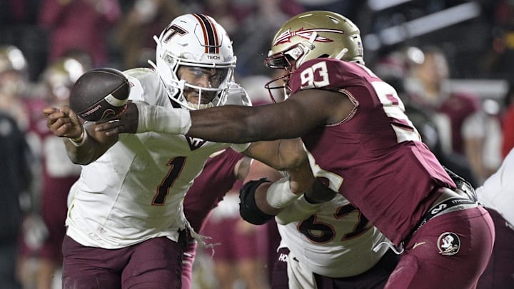 Nov 15, 2025; Tallahassee, Florida, USA; Virginia Tech Hokies quarterback Kyron Drones (1) has the ball knocked away by Florida State Seminoles defensive lineman Mandrell Desir (93) during the second half at Doak S. Campbell Stadium. Mandatory Credit: Melina Myers-Imagn Images