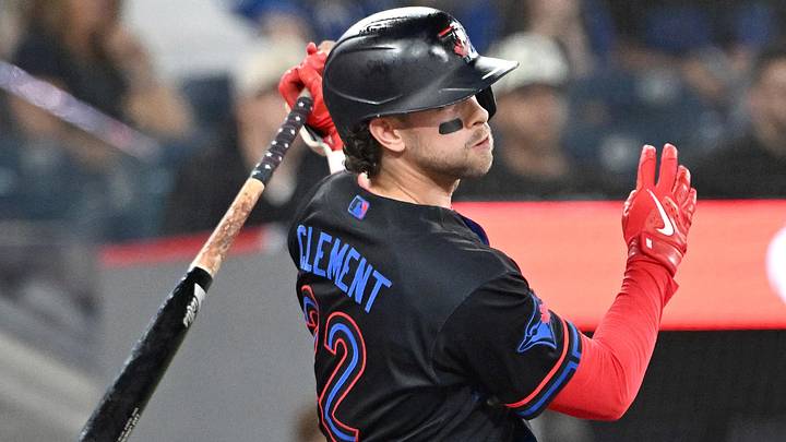 Blue Jays second baseman Ernie Clement (22) hits a single against the Texas Rangers 