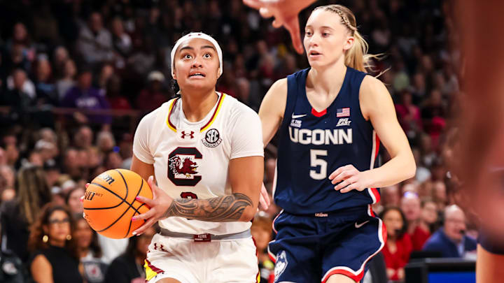 Feb 16, 2025; Columbia, South Carolina, USA; South Carolina Gamecocks guard Te-Hina Paopao (0) drives past UConn Huskies guard Paige Bueckers (5) in the first half at Colonial Life Arena. Mandatory Credit: Jeff Blake-Imagn Images