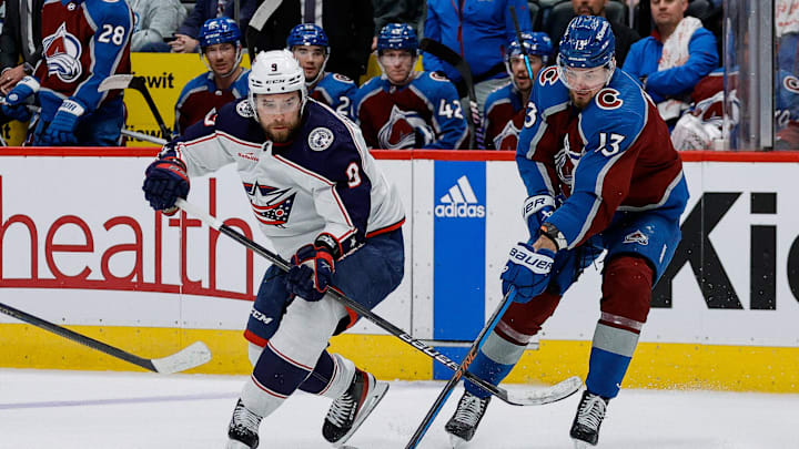 Mar 22, 2024; Denver, Colorado, USA; Columbus Blue Jackets defenseman Ivan Provorov (9) and Colorado Avalanche right wing Valeri Nichushkin (13) battle for the puck in the third period at Ball Arena. Mandatory Credit: Isaiah J. Downing-Imagn Images