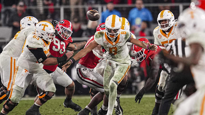 Nov 16, 2024; Athens, Georgia, USA; Tennessee Volunteers quarterback Nico Iamaleava (8) is hit by Georgia Bulldogs linebacker Damon Wilson II (10) and fumbles the ball recovered by Georgia during the second half at Sanford Stadium. Mandatory Credit: Dale Zanine-Imagn Images