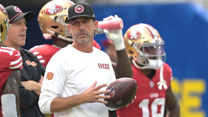 Sep 22, 2024; Inglewood, California, USA;  San Francisco 49ers head coach Kyle Shanahan looks on as players warm up prior to the game against the Los Angeles Rams at SoFi Stadium. Mandatory Credit: Jayne Kamin-Oncea-Imagn Images
