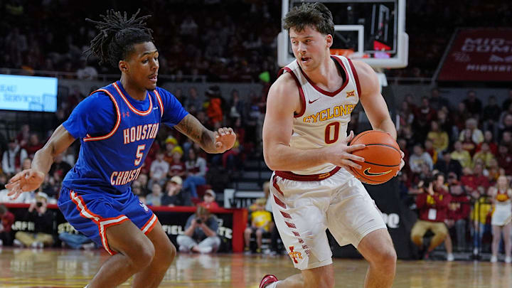 Iowa State Cyclones guard Nate Heise (0) drives with the ball around Houston Christian Huskies guard D'Aundre Samuels (5) during the first half in the NCAA men’s basketball on Dec. 29. 2025, at Hilton Coliseum in Ames, Iowa.