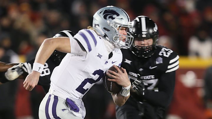 Kansas State Wildcats quarterback Avery Johnson (2) runs with the ball around Iowa State Cyclones linebacker Will McLaughlin (23) during the first quarter in the NCAA football at Jack Trice Stadium on Saturday, Nov. 30, 2024, in Ames, Iowa.