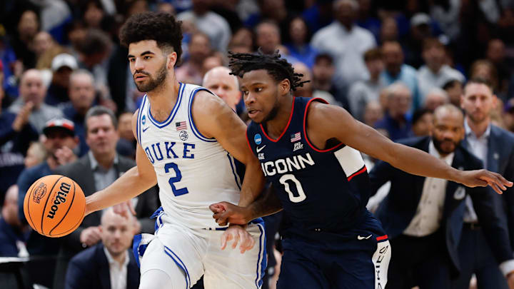 Mar 29, 2026; Washington, DC, USA; Duke basketball guard Cayden Boozer (2) dribbles the ball against UConn Huskies guard Malachi Smith (0) in the second half during an Elite Eight game of the East Regional of the men's 2026 NCAA Tournament at Capital One Arena.