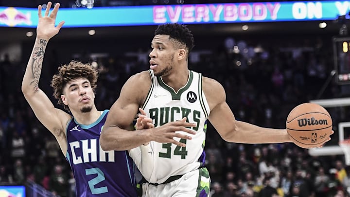 Dec 1, 2021; Milwaukee, Wisconsin, USA;  Milwaukee Bucks forward Giannis Antetokounmpo (34) drives for the basket against Charlotte Hornets guard LaMelo Ball (2) in the fourth quarter at Fiserv Forum. Mandatory Credit: Benny Sieu-Imagn Images