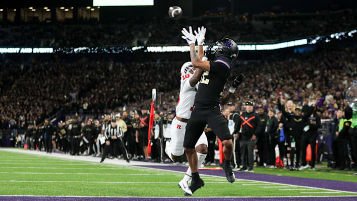 Huskies wide receiver Denzel Boston (12) catches a 23-yard touchdown pass over the hands of Rutgers' Jacobie Henderson. Huskies wide receiver Denzel Boston (12) catches a 23-yard touchdown pass over the hands of Rutgers' Jacobie Henderson.