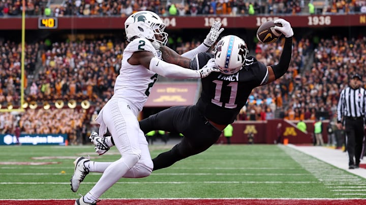 Nov 1, 2025; Minneapolis, Minnesota, USA; Minnesota Golden Gophers wide receiver Javon Tracy (11) attempts to catch a pass as Michigan State Spartans defensive back Aydan West (2) defends during the first half at Huntington Bank Stadium.