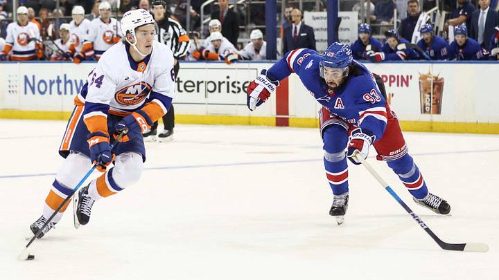Sep 22, 2026; New York, New York, USA;  New York Islanders center Calum Ritchie (64) and New York Rangers center Mika Zibanejad (93) battle for control of the puck in the third period at Madison Square Garden.  Mandatory Credit: Wendell Cruz-Imagn Images