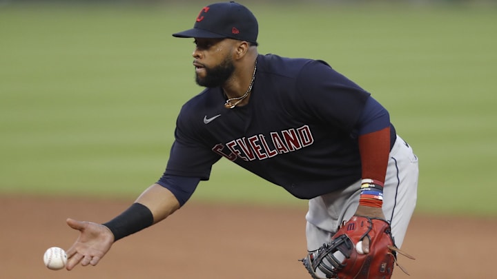 Aug 15, 2020; Detroit, Michigan, USA; Cleveland Indians first baseman Carlos Santana (41) tosses the ball to first base for an out during the sixth inning against the Detroit Tigers at Comerica Park. Mandatory Credit: Raj Mehta-Imagn Images