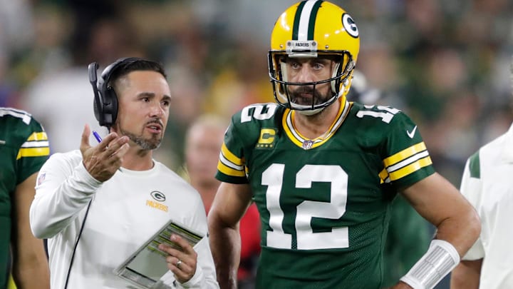 Green Bay Packers head coach Matt LaFleur talks with former quarterback Aaron Rodgers (12) in between quarters against the Chicago Bears during their game on Sep 18, 2022, in Green Bay, Wisconsin.