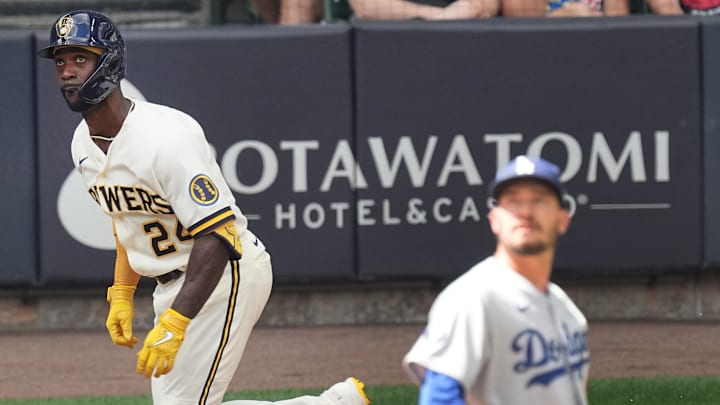 Brewers designated hitter Andrew McCutchen (24) watches his two-run home run off of Los Angeles Dodgers starting pitcher Andrew Heaney (28) during the third inning at American Family Field. Mandatory Credit: Mark Hoffman-USA TODAY NETWORK