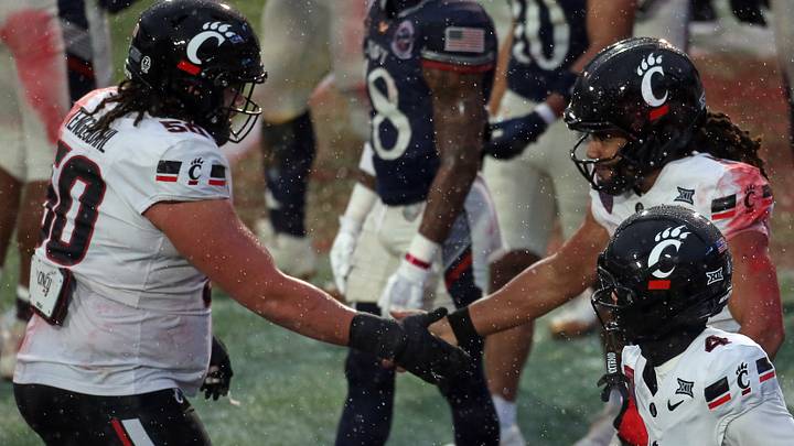 Jan 2, 2026; Memphis, TN, USA; Cincinnati Bearcats quarterback Samaj Jones (5) reacts with offensive lineman Evan Tengesdahl (50) after a touchdown run during the second quarter against the Navy Midshipmen at Simmons Bank Liberty Stadium. Mandatory Credit: Petre Thomas-Imagn Images Jan 2, 2026; Memphis, TN, USA; Cincinnati Bearcats quarterback Samaj Jones (5) reacts with offensive lineman Evan Tengesdahl (50) after a touchdown run during the second quarter against the Navy Midshipmen at Simmons Bank Liberty Stadium. Mandatory Credit: Petre Thomas-Imagn Images