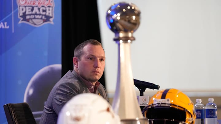 Arizona State head coach Kenny Dillingham listens to a question during a joint news conference with Texas head coach Steve Sarkisian before facing off in the Chick-fil-A Peach Bowl.