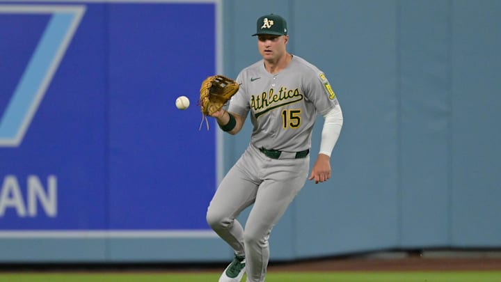 May 15, 2025; Los Angeles, California, USA; Athletics center fielder Seth Brown (15) is unable to catch a single by Los Angeles Dodgers third baseman Max Muncy, not pictured, during the second inning of the game at Dodger Stadium. Mandatory Credit: Jayne Kamin-Oncea-Imagn Images