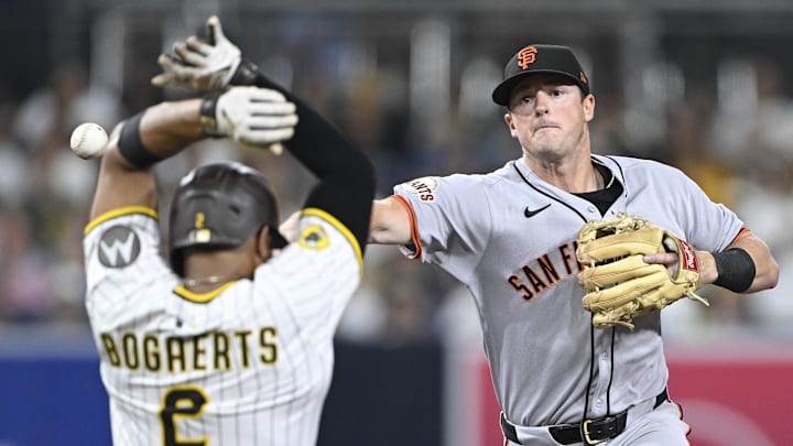 San Francisco Giants second baseman Tyler Fitzgerald (49) throws over San Diego Padres shortstop Xander Bogaerts (2) as he tries to turn a double play during the fourth inning at Petco Park. San Francisco Giants second baseman Tyler Fitzgerald (49) throws over San Diego Padres shortstop Xander Bogaerts (2) as he tries to turn a double play during the fourth inning at Petco Park.