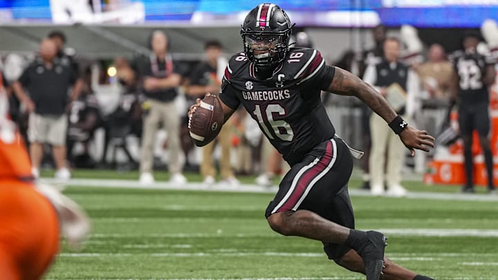 Aug 31, 2025; Atlanta, Georgia, USA; South Carolina Gamecocks quarterback LaNorris Sellers (16) rolls out of the pocket against the Virginia Tech Hokies during the first half at Mercedes-Benz Stadium. Mandatory Credit: Dale Zanine-Imagn Images