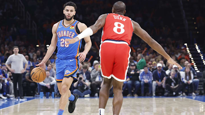 Jan 2, 2025; Oklahoma City, Oklahoma, USA; Oklahoma City Thunder guard Ajay Mitchell (25) dribbles against Los Angeles Clippers guard Kris Dunn (8) during the second quarter at Paycom Center. Mandatory Credit: Alonzo Adams-Imagn Images Jan 2, 2025; Oklahoma City, Oklahoma, USA; Oklahoma City Thunder guard Ajay Mitchell (25) dribbles against Los Angeles Clippers guard Kris Dunn (8) during the second quarter at Paycom Center. Mandatory Credit: Alonzo Adams-Imagn Images