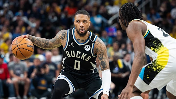 Apr 22, 2025; Indianapolis, Indiana, USA: Milwaukee Bucks guard Damian Lillard (0) dribbles the ball while Indiana Pacers forward Aaron Nesmith (23) defends during game two of first round for the 2024 NBA Playoffs at Gainbridge Fieldhouse. Mandatory Credit: Trevor Ruszkowski-Imagn Images