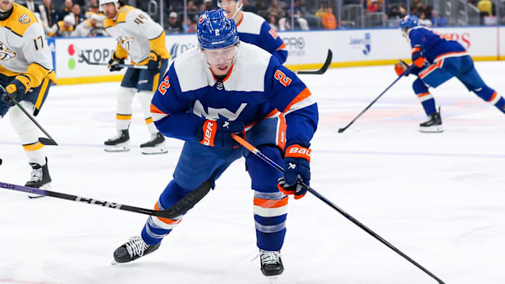 Apr 6, 2024; Elmont, New York, USA; New York Islanders defenseman Mike Reilly (2) skates with the puck against the Nashville Predators during the second period at UBS Arena. Mandatory Credit: Tom Horak-Imagn Images